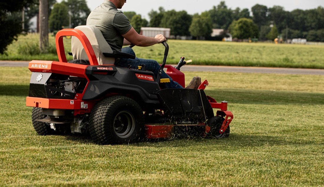 A technician operating a zero-turn mower on turf, the kind of complex equipment FieldCraft helps diagnose and service.
